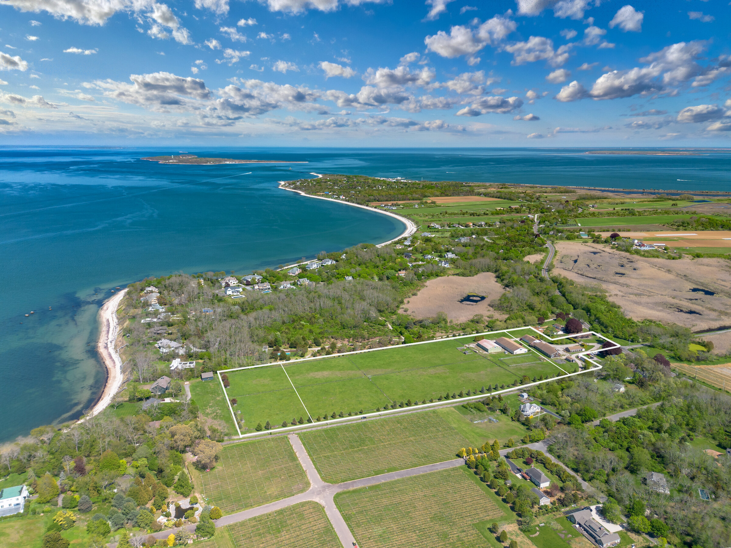 Aerial of the estate with Long Island Sound and the Orient lighthouse on the horizon